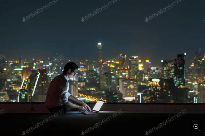 Man working on computer over cityscape