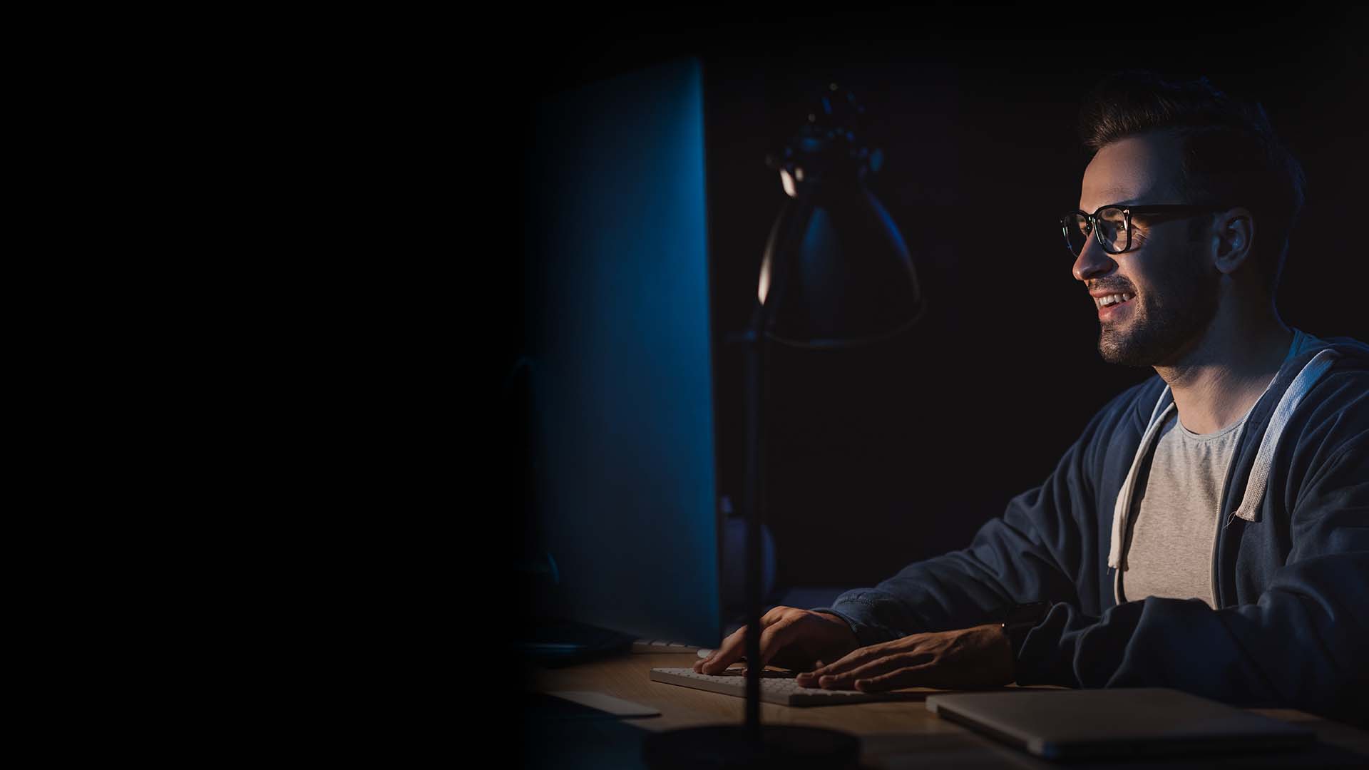 man working on computer in the dark