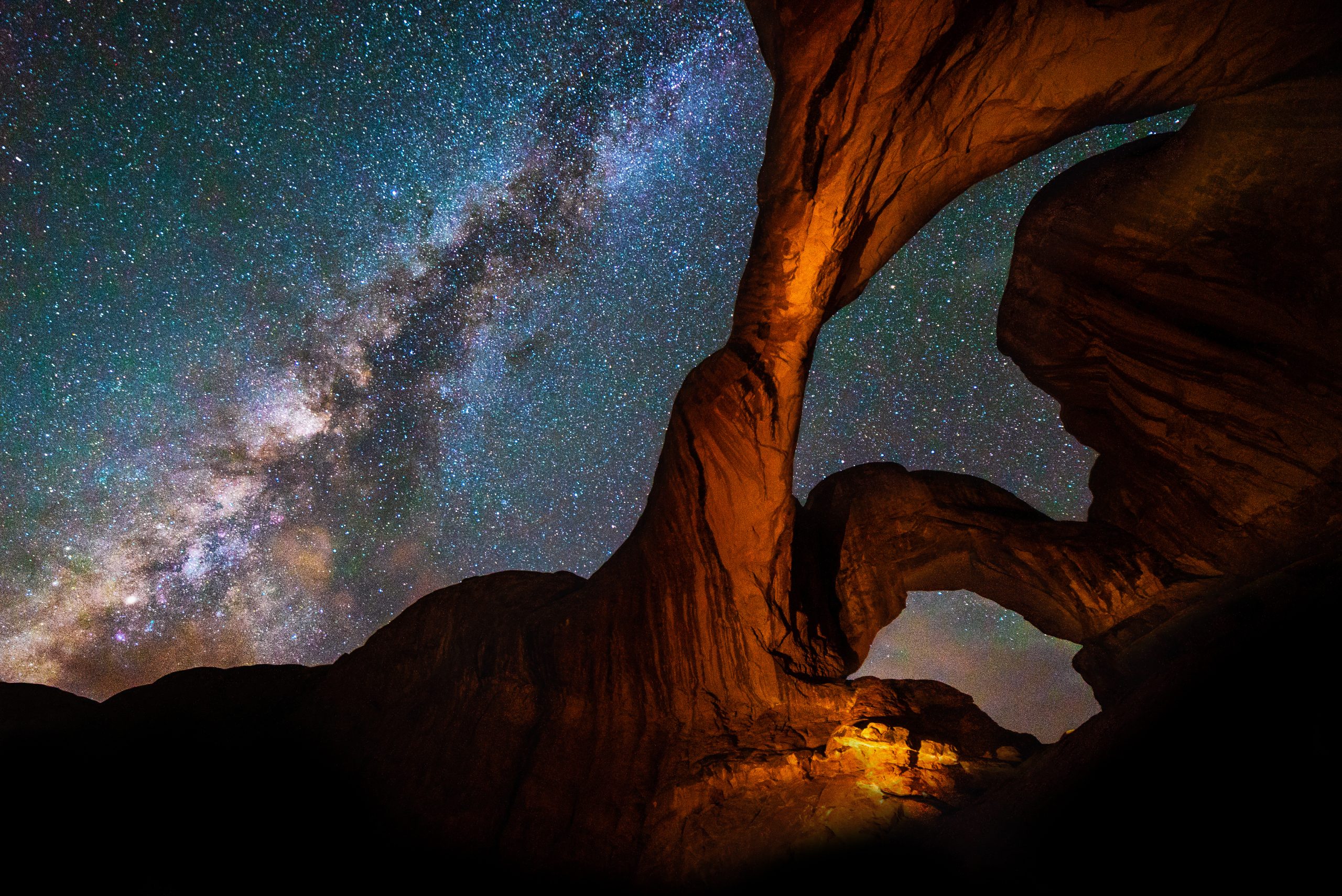 Starry night sky with rock formations