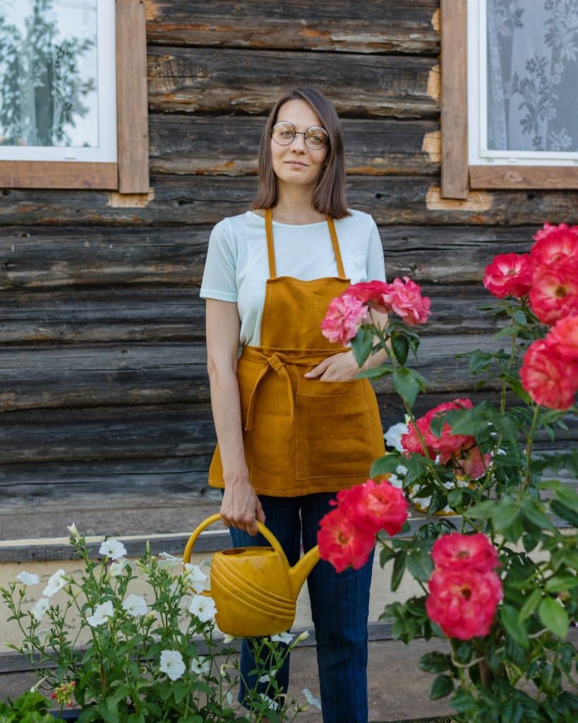 Woman who is taking watering flowers