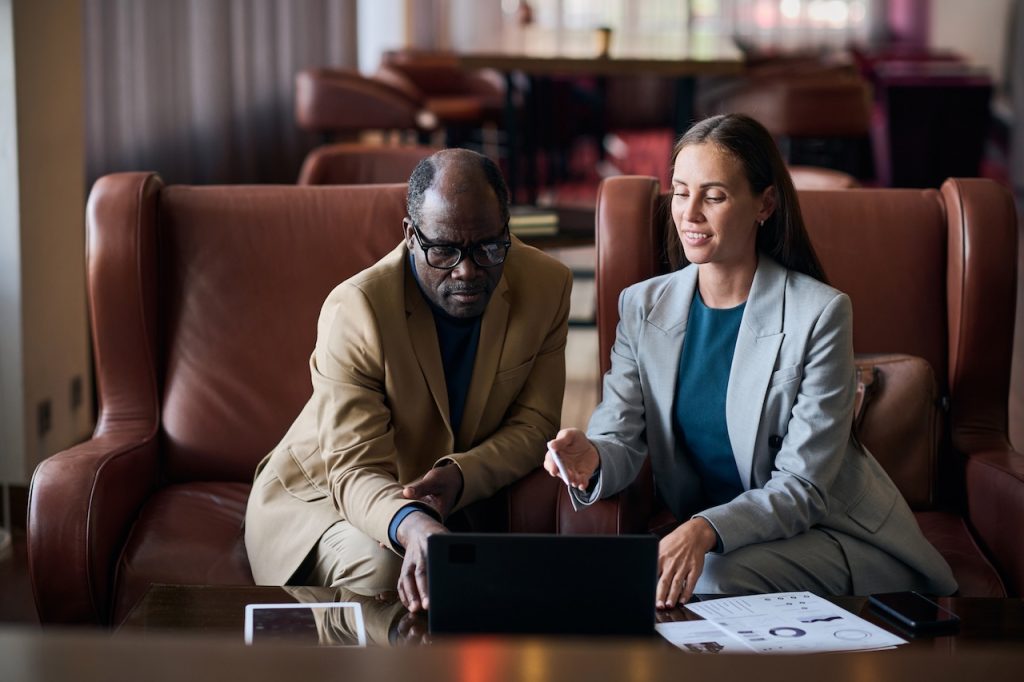 colleagues using cloud backup for small business during meeting