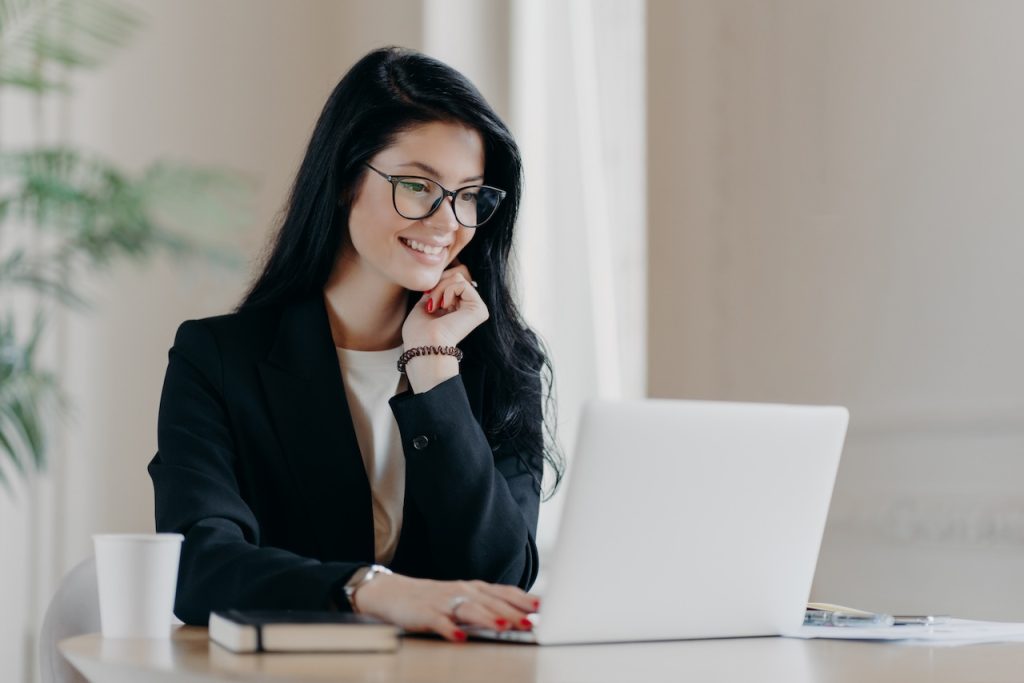 woman working in office getting assistance from outsourced tech support