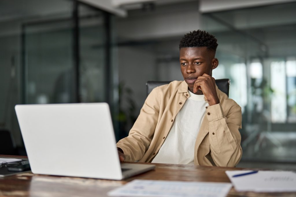 employee working in office on computer using outsourced technical support services