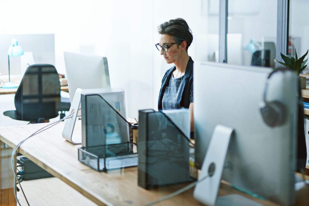 employee working on computer using backup and disaster recovery solutions