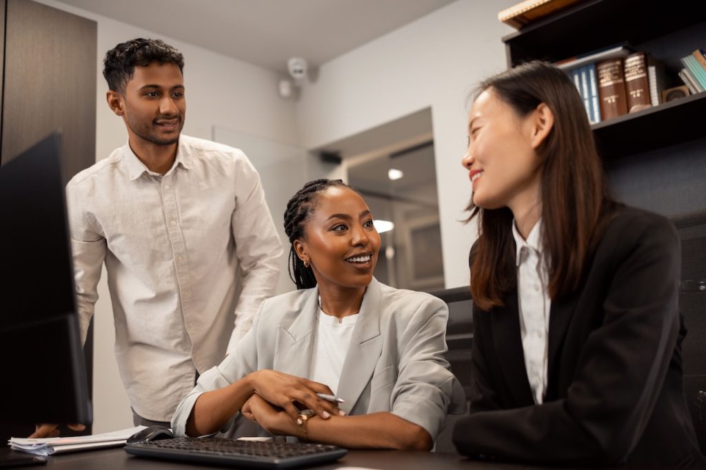 colleagues on computer using it solutions for law firms