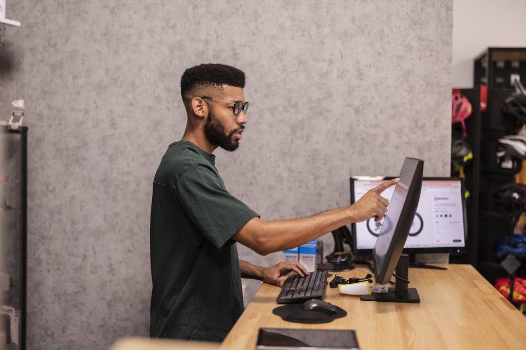 employee working on computer in shop