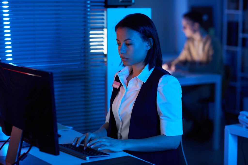 it professional performing network vulnerability assessment on computer in office