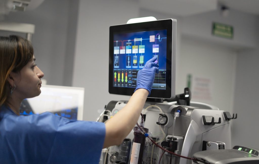 technician working on computer monitor following hipaa compliance services