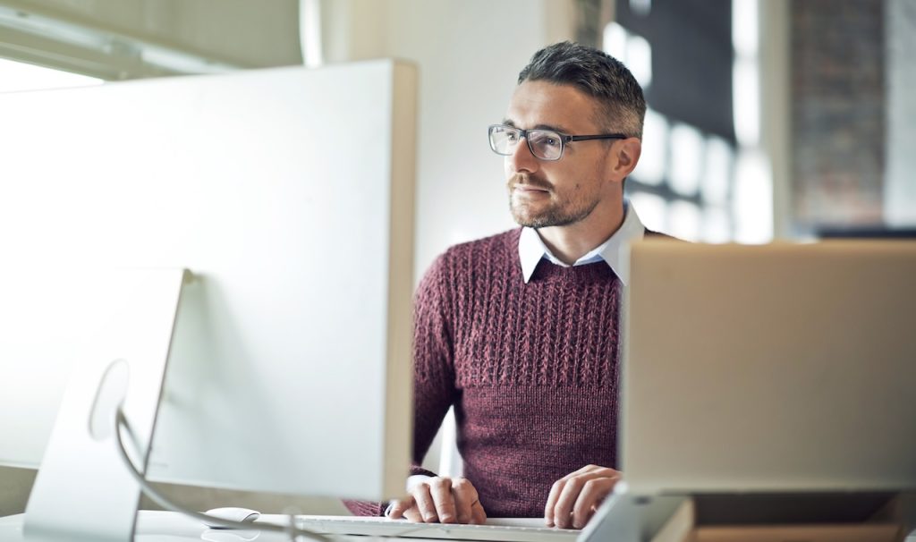 man working securely online at office with help from it security experts