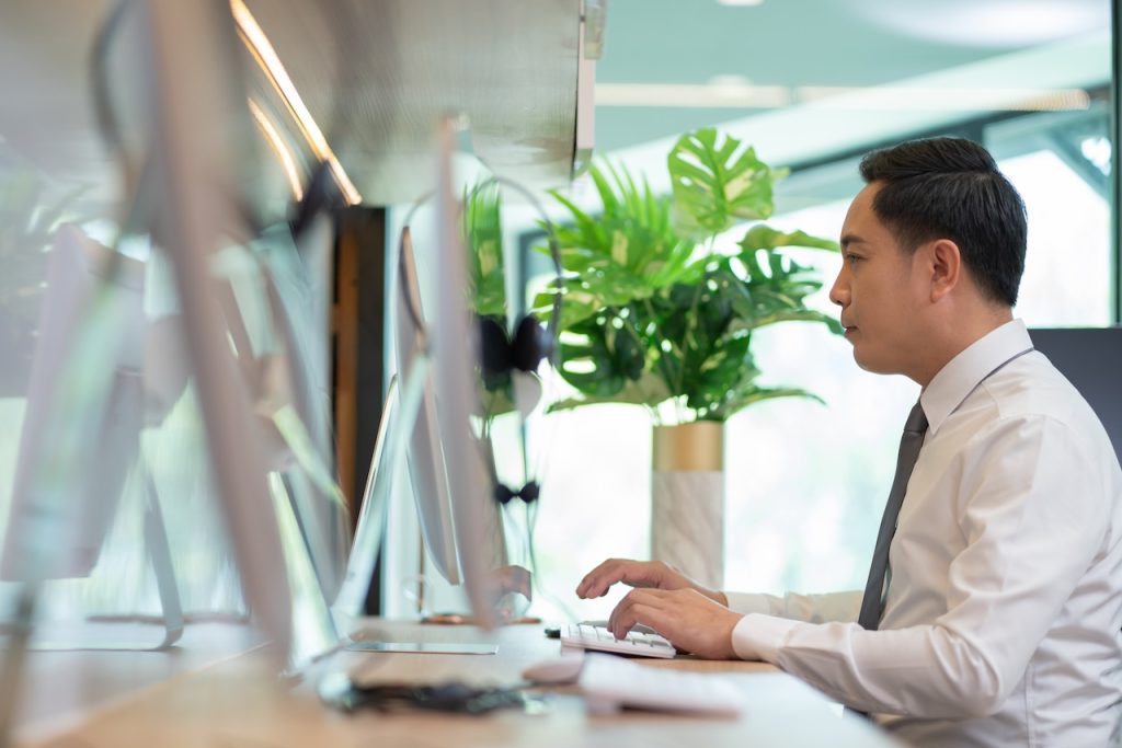 focused employee working on computer in office