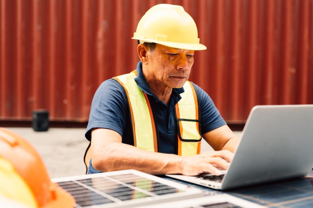 construction worker working on computer on site