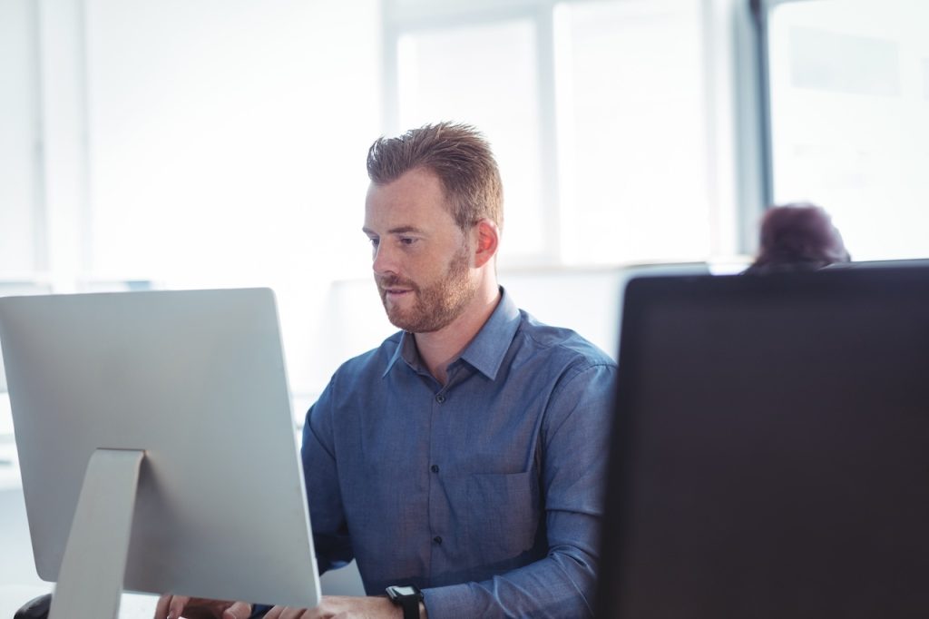 male employee working on computer in office