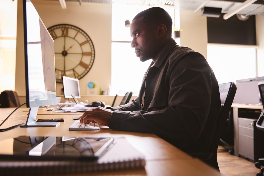 male employee working in office on computer