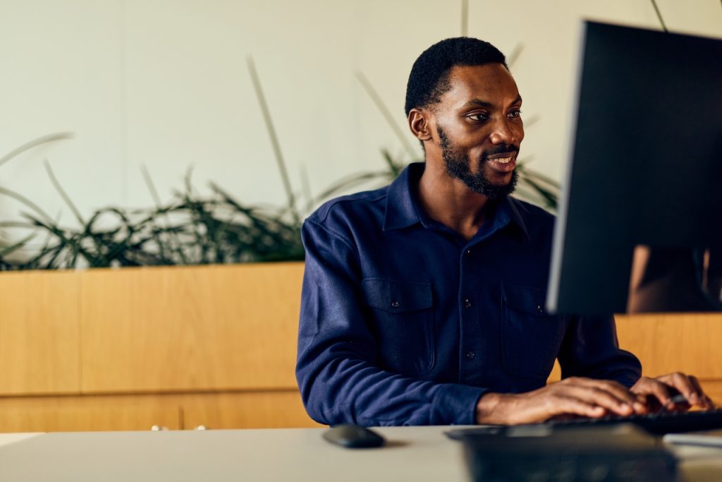 man in office working on desktop computer