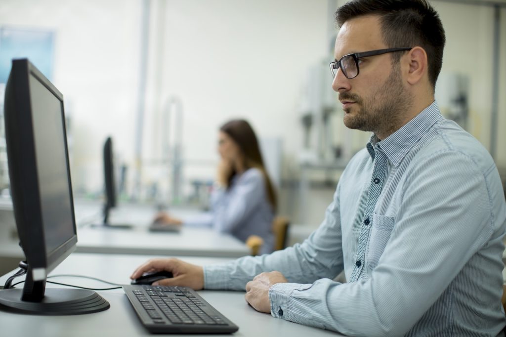 profile view of man working on computer in office
